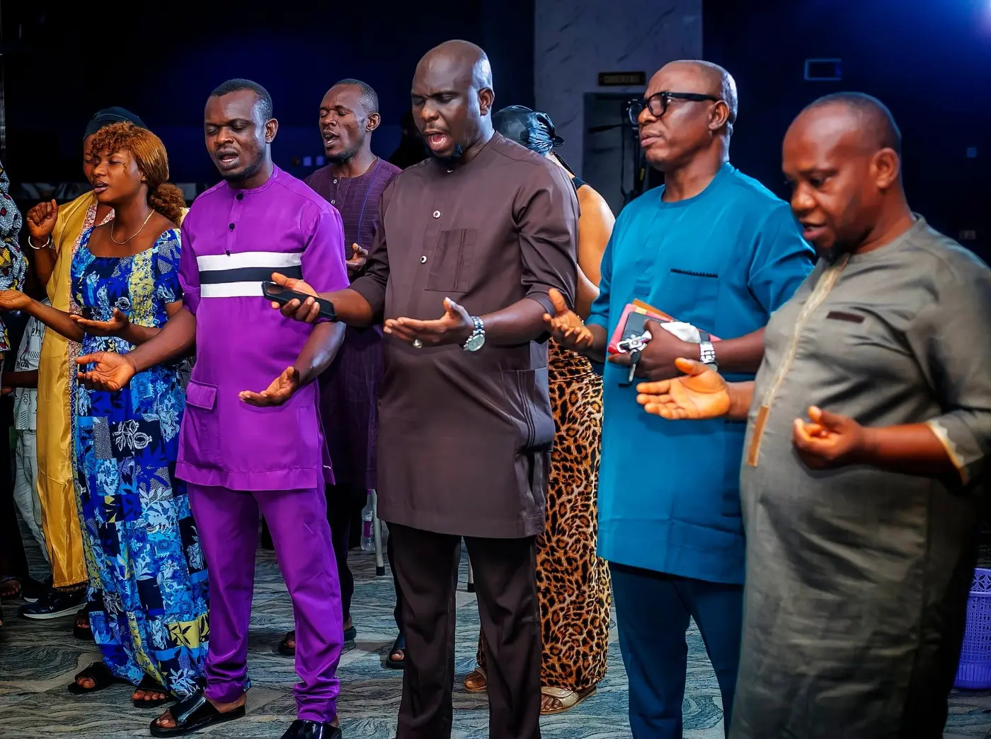 Church leaders and members praying together